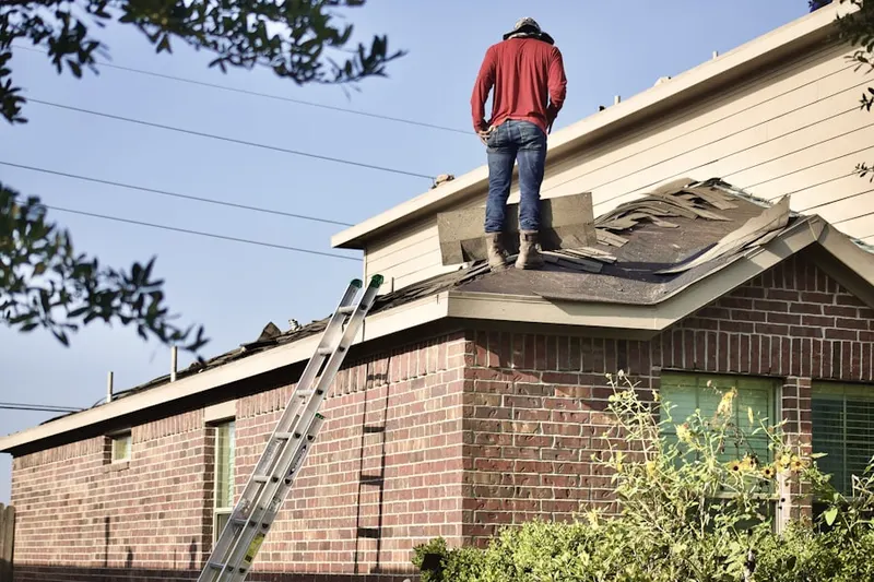 Professional roofer working on a residential roof in Maple Forge